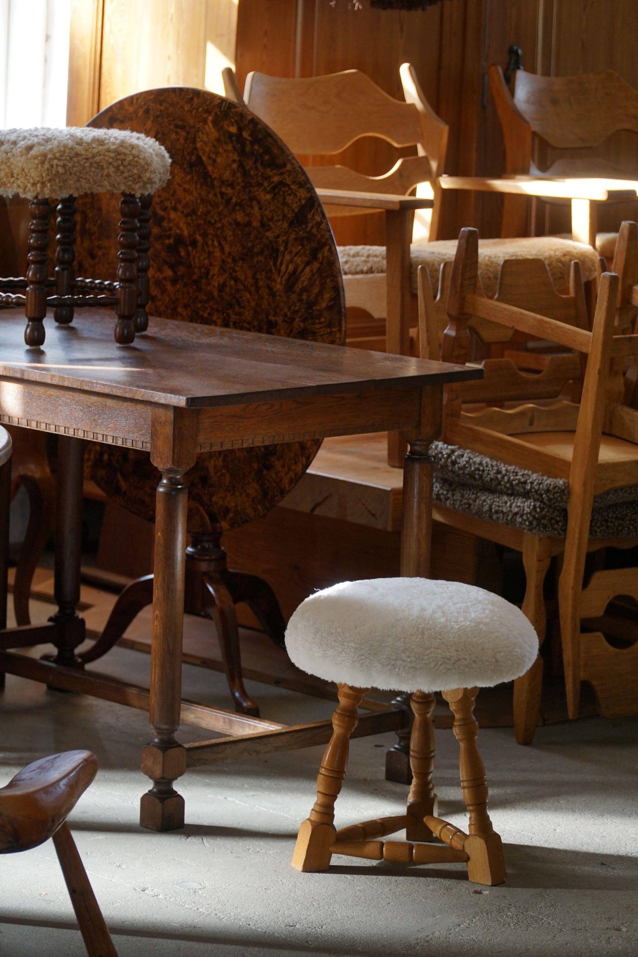 Modern Danish, a pair of tripod stools, seats reupholstered in lambswool, 1950s.