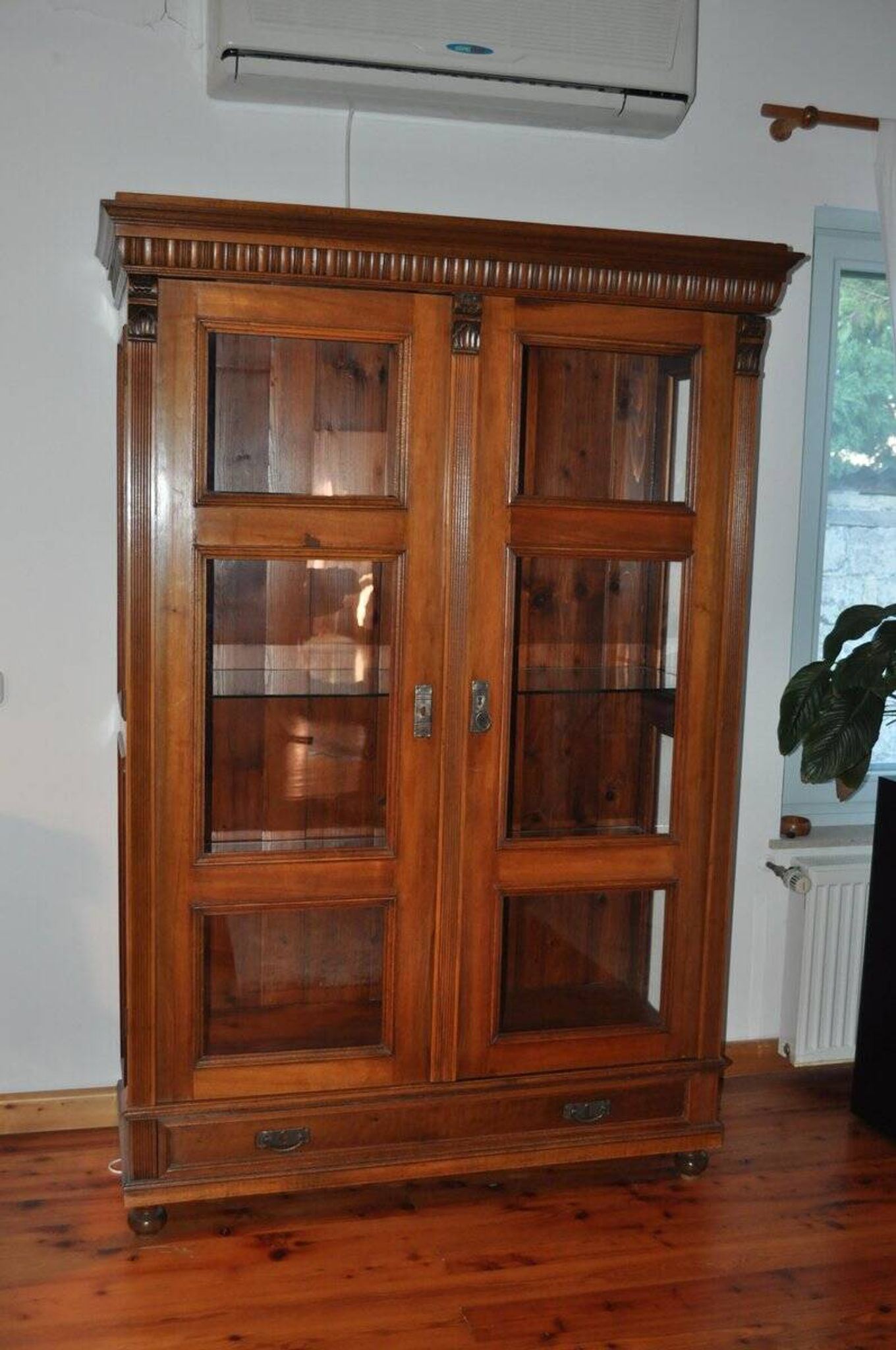 Antique wooden and glass cabinet in brown - 1900 style display case with carved mouldings.