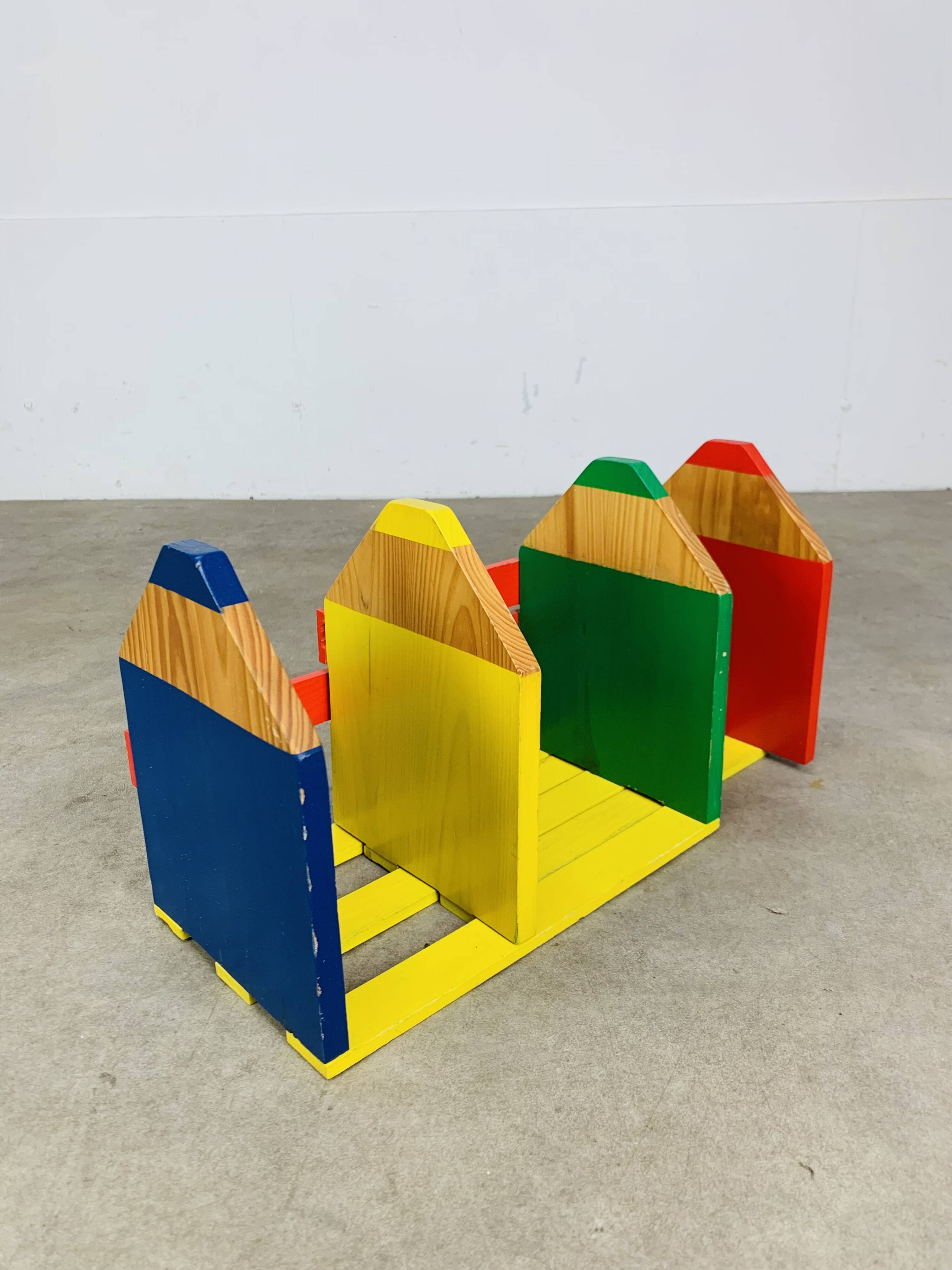 Modular wall-mounted pencil shelf in Pierre Sala style, for children.