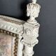 Antique Louis XVI style chair with patinated wood and floral fabric.