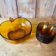 Salad bowl and apple raviers in amber glass 70 years
