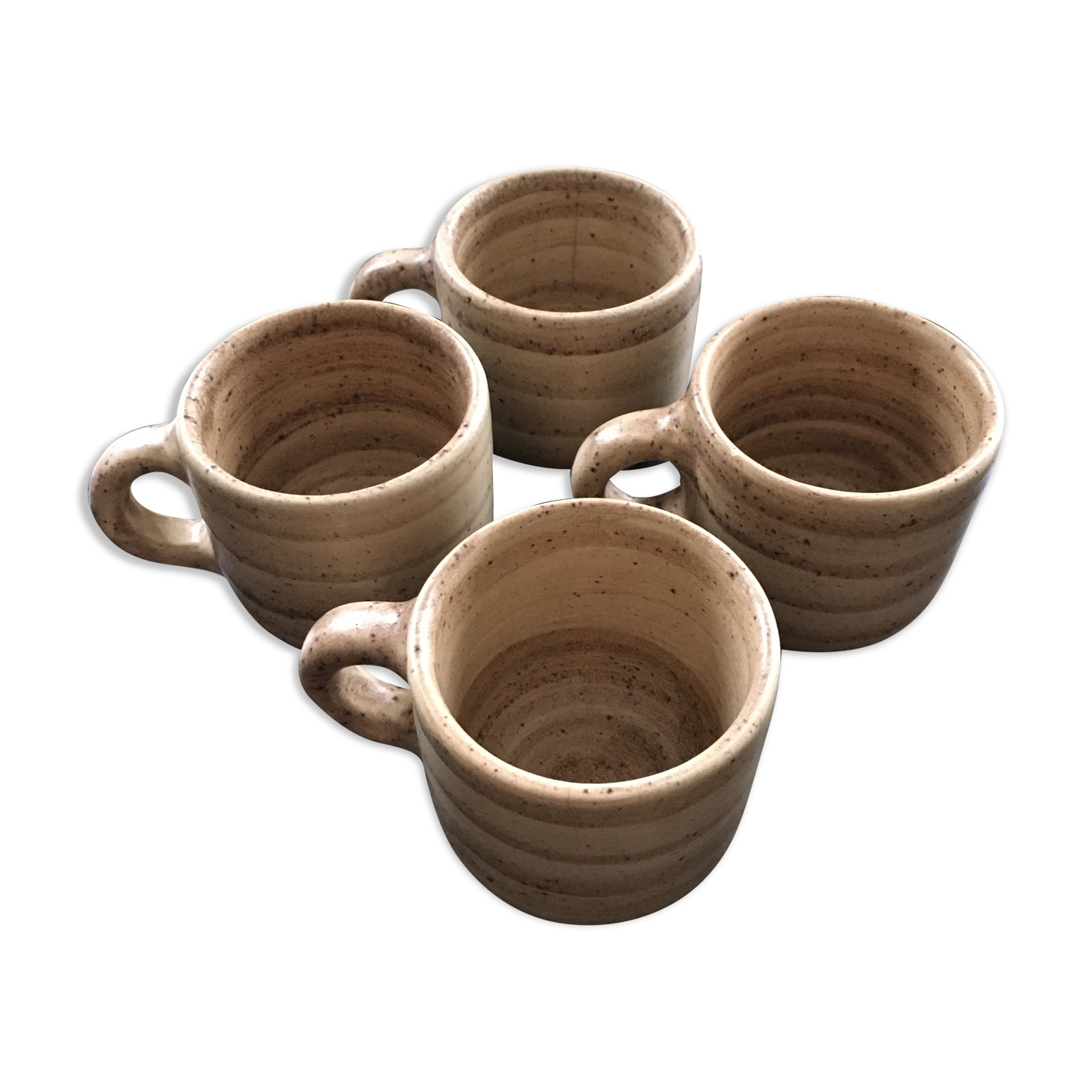 Set of 4 beige stoneware mugs.