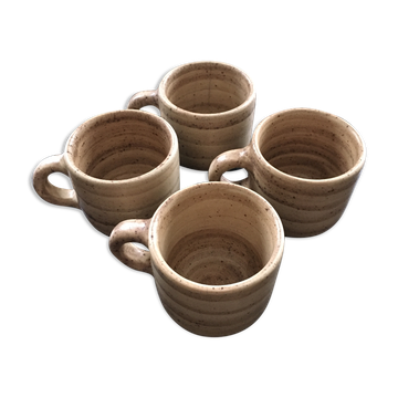 Set of 4 beige stoneware mugs.
