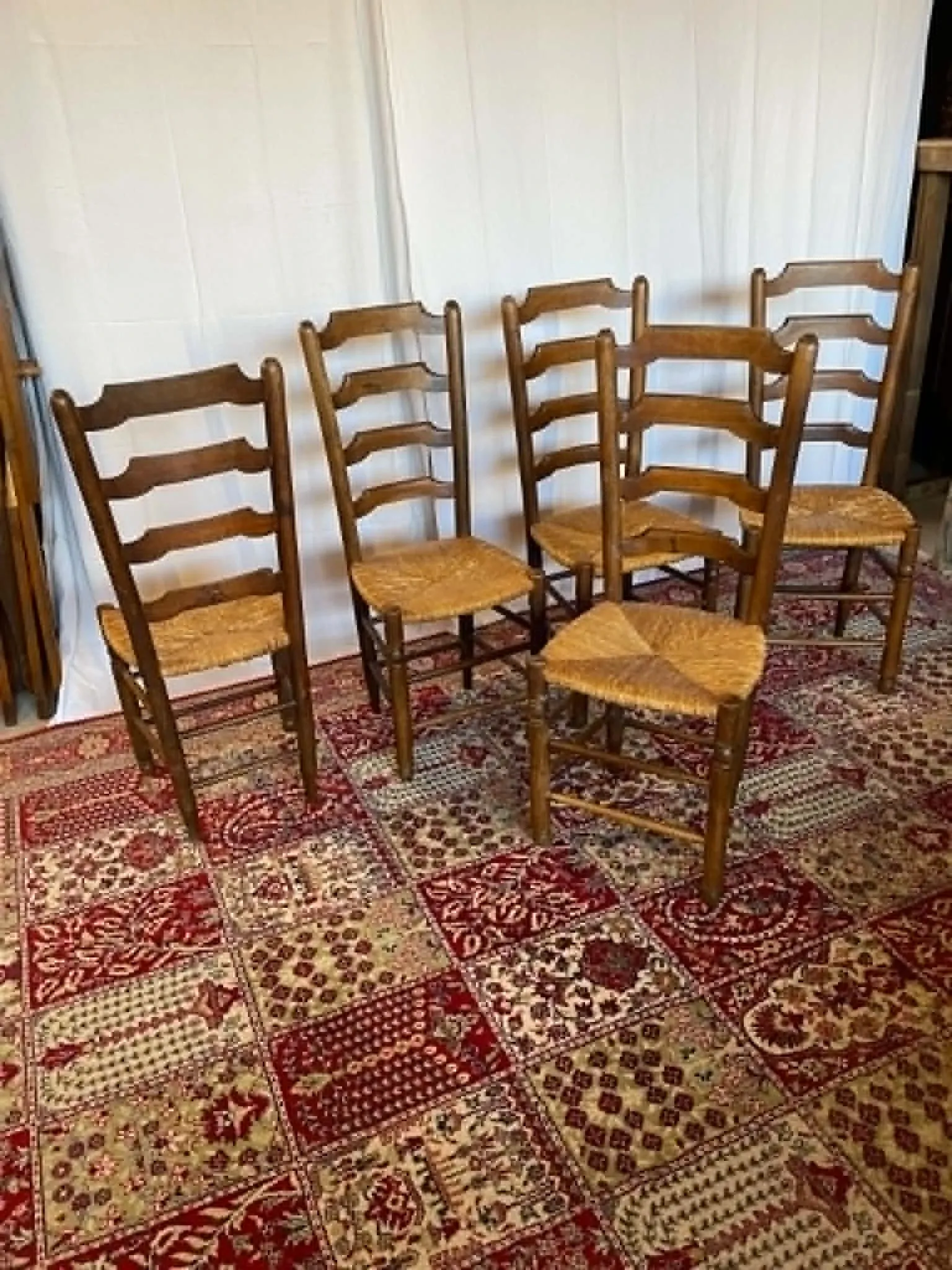 Set of 5 antique solid oak chairs with straw seats.