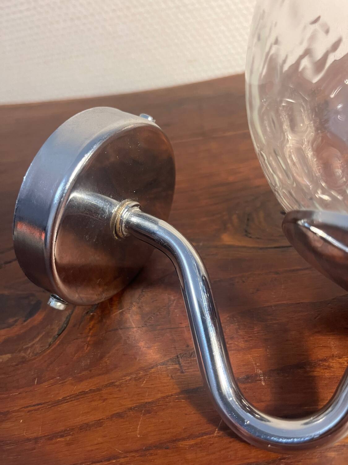 Delmas chrome wall light with chiseled glass globe