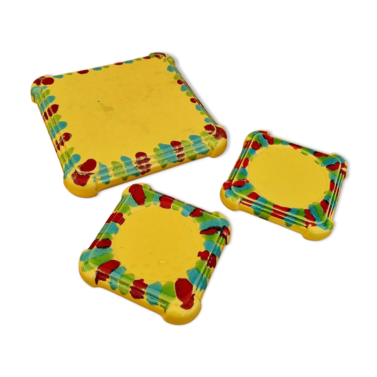 Yellow ceramic trivet and bottle coaster with vintage painted decoration.