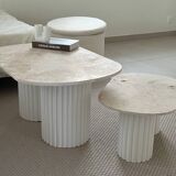 Oval coffee table duo travertine and white fluted wooden legs.