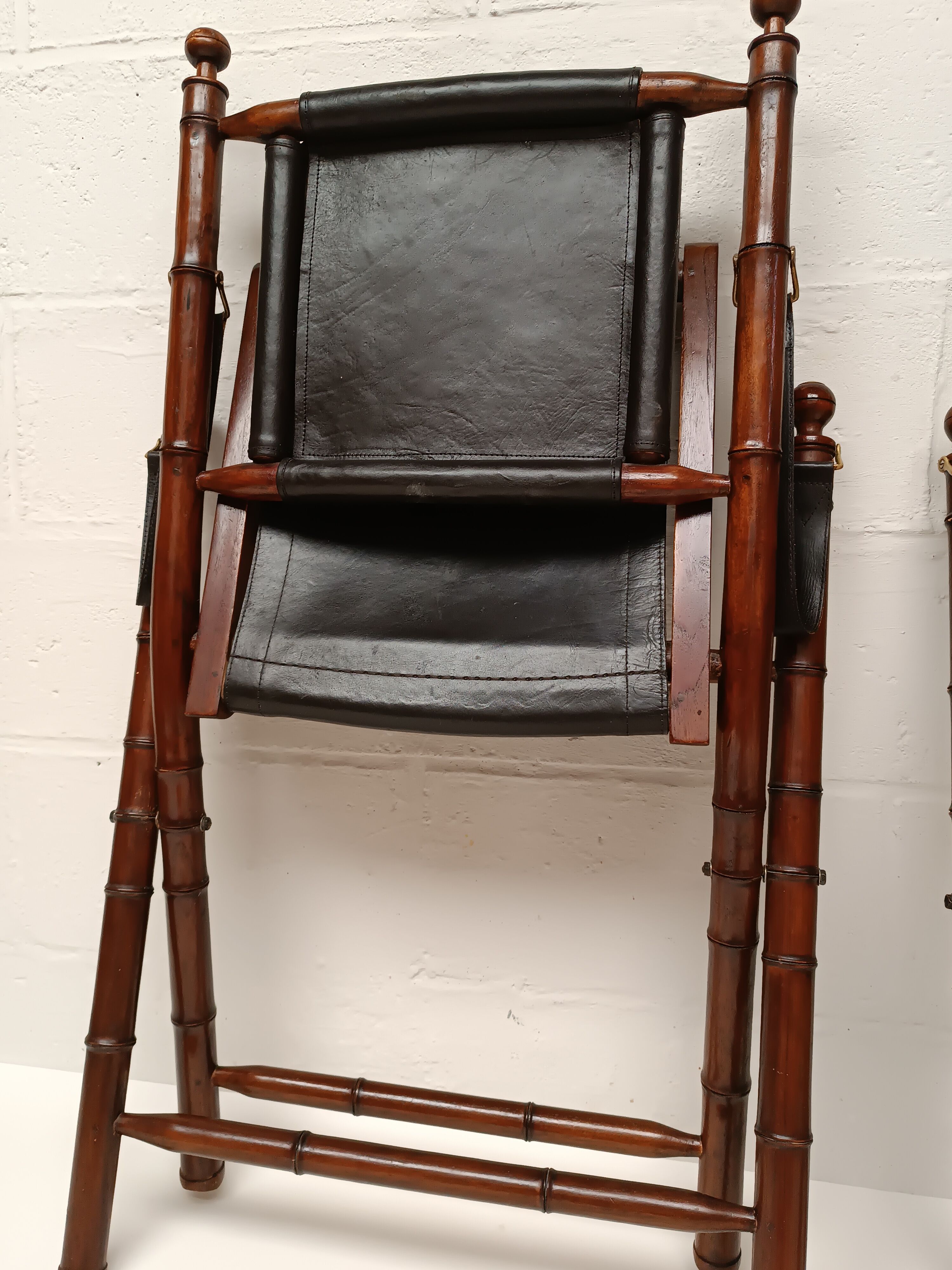 Pair of vintage "safari" folding armchairs in mahogany and leather