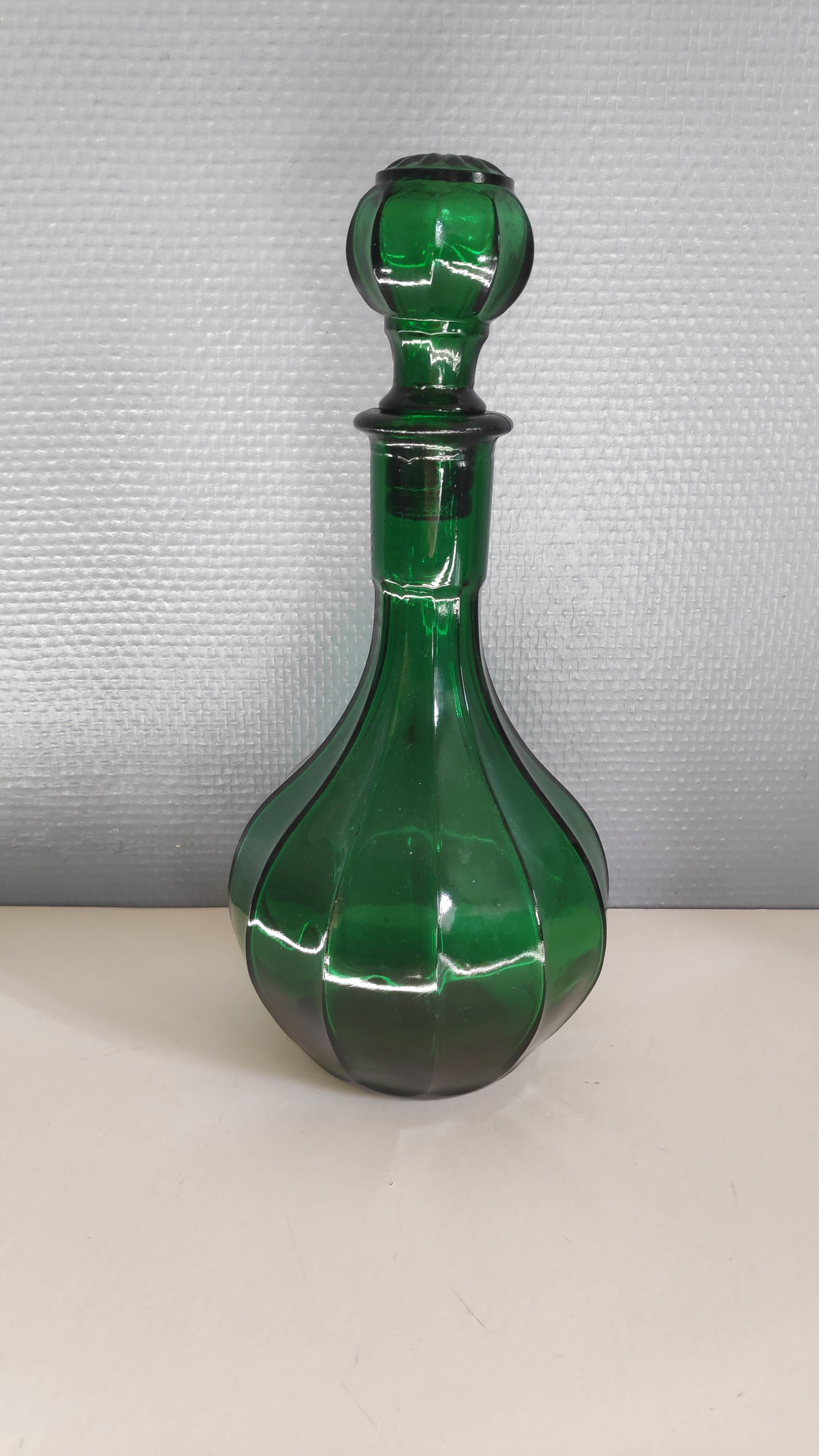 Old green carafe with ribbed lines