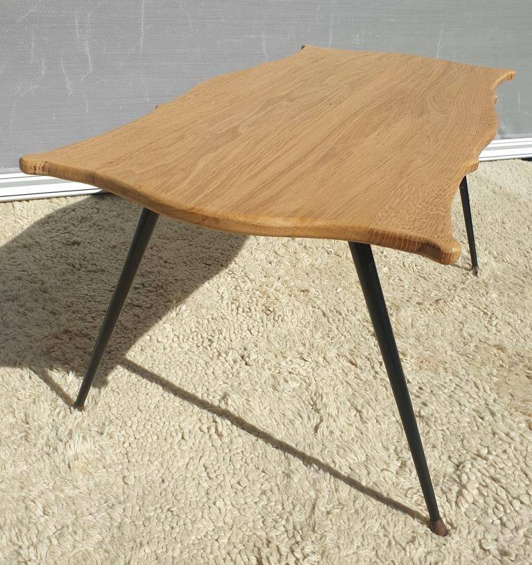 Violin-shaped coffee table with brass legs