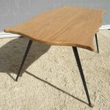 Violin-shaped coffee table with brass legs