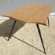 Violin-shaped coffee table with brass legs