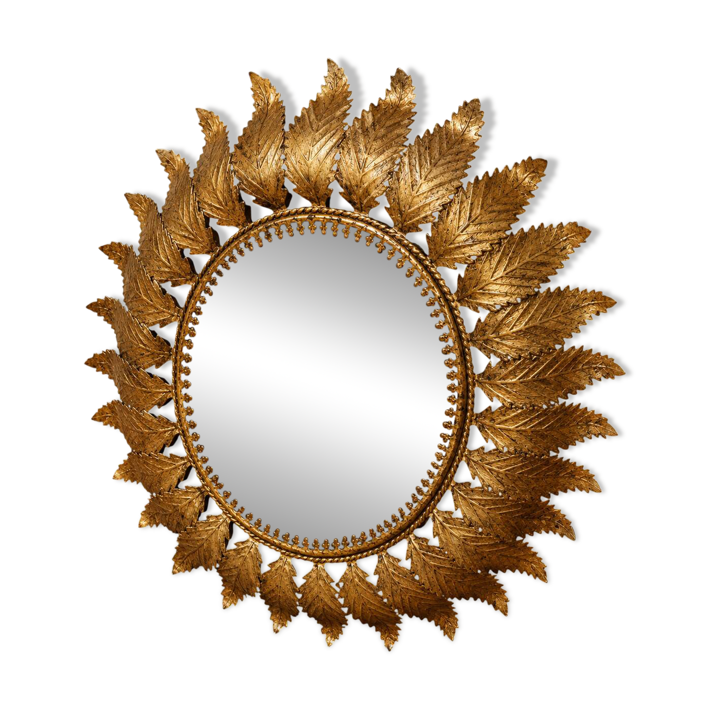 Golden metal sun mirror with leaf decoration