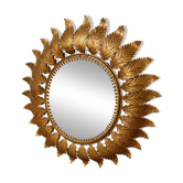 Golden metal sun mirror with leaf decoration