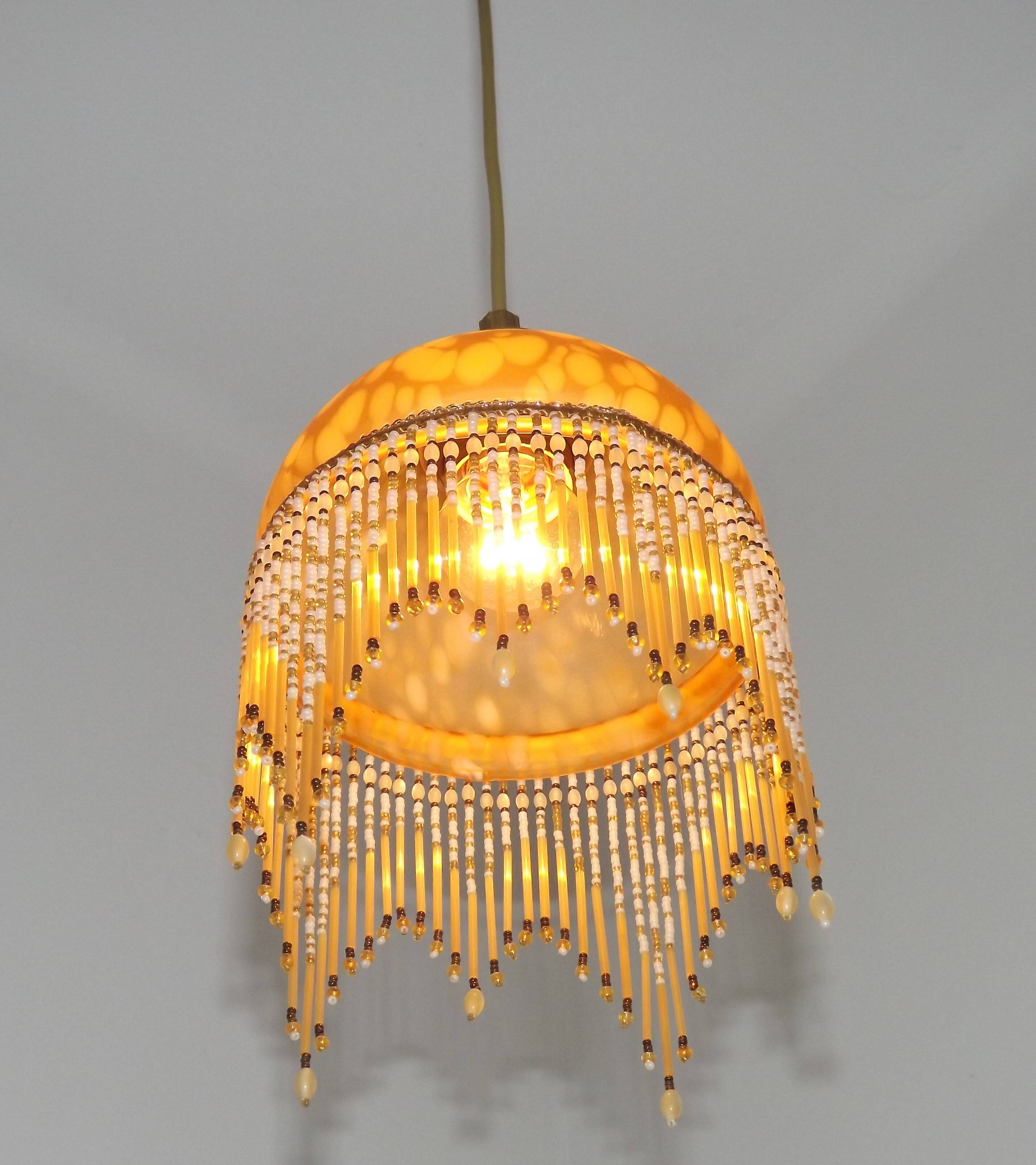 Vintage French amber mottled glass hanging ceiling light with beaded fringe.