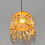 Vintage French amber mottled glass hanging ceiling light with beaded fringe.