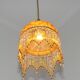 Vintage French amber mottled glass hanging ceiling light with beaded fringe.