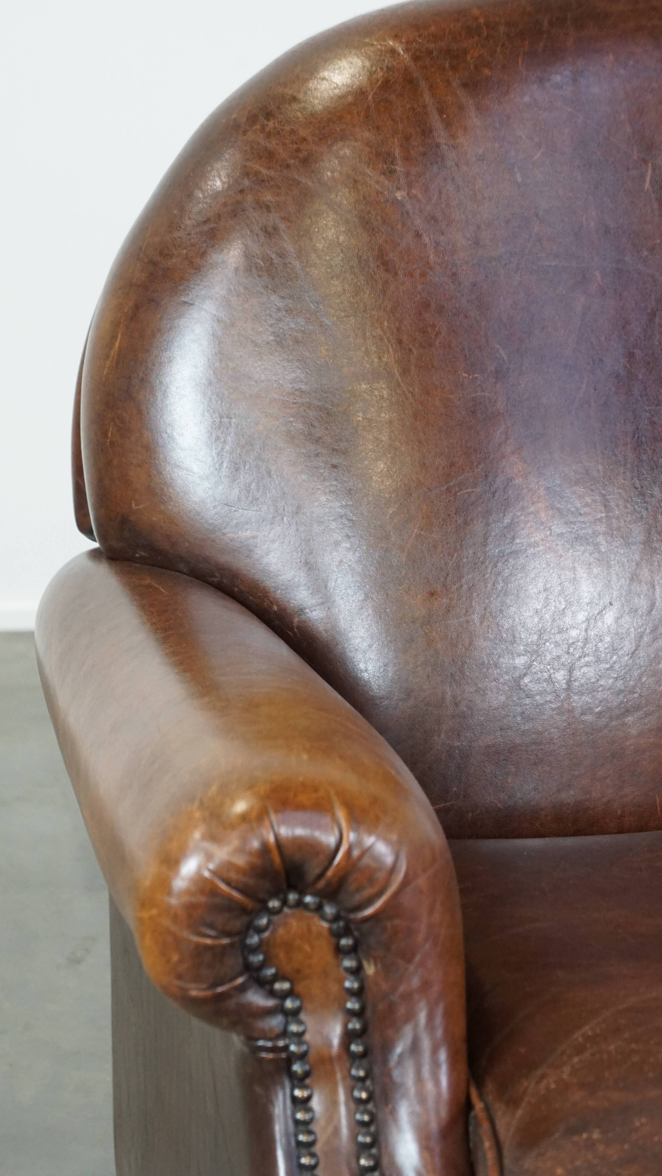 Sheep leather armchair on wheels
