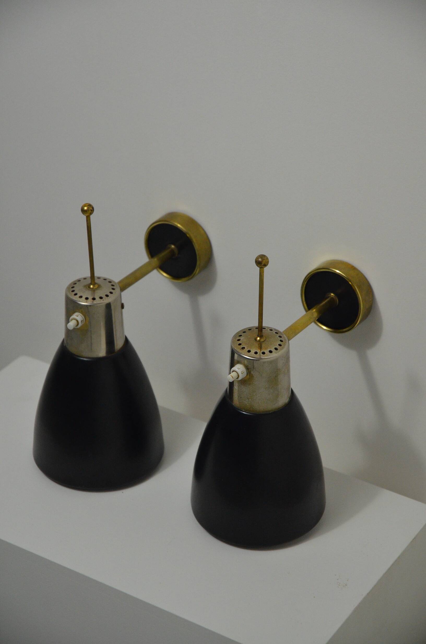 Pair of Monix wall lights in black lacquered metal and brass