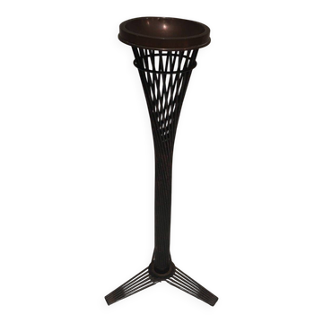 Brass ashtray on a stand made of black lacquered metal wire.