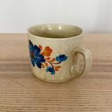 Speckled stoneware cup with blue flower