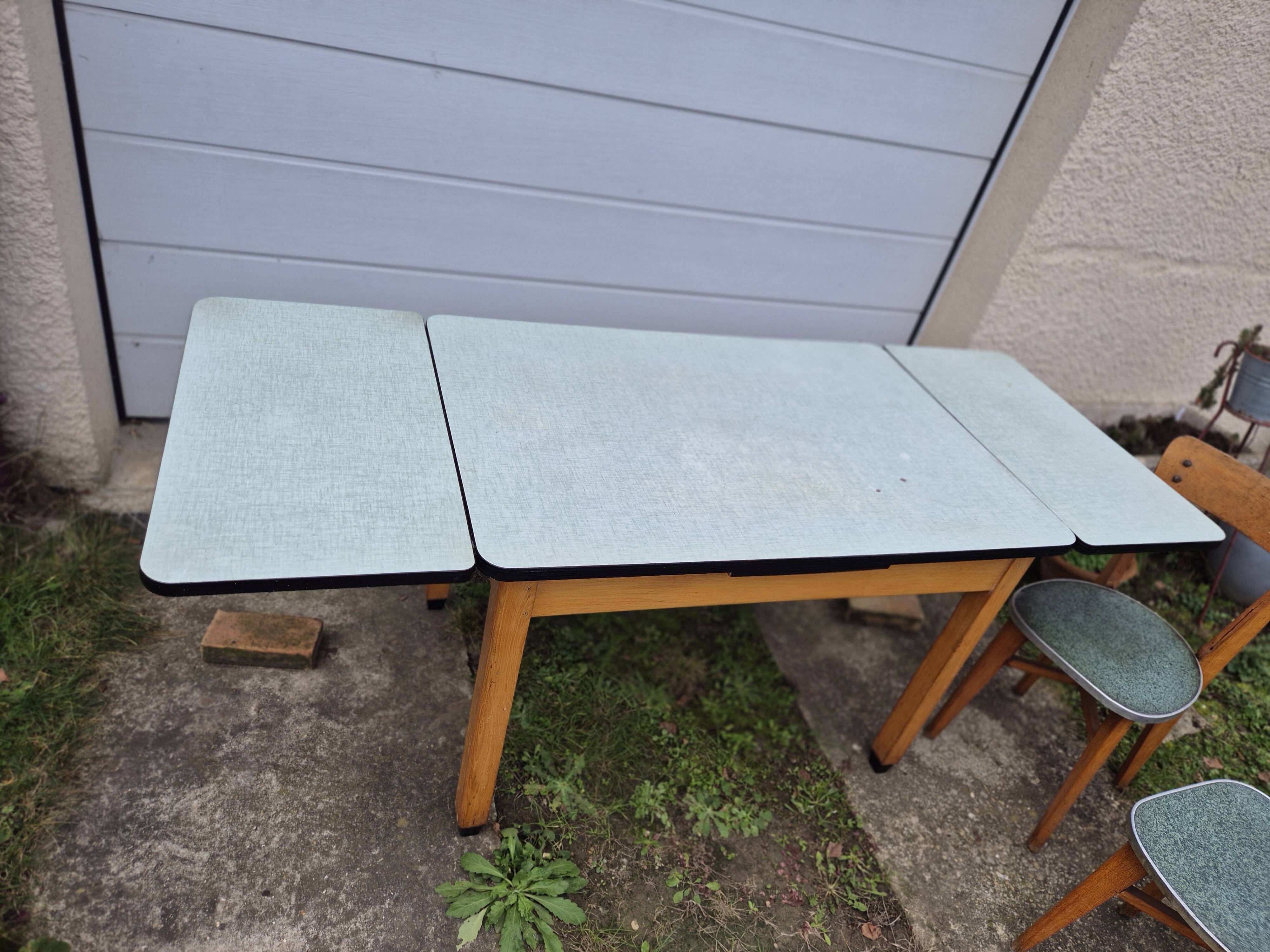 Vintage Scandinavian table and chair set with a wooden frame and formica top.
