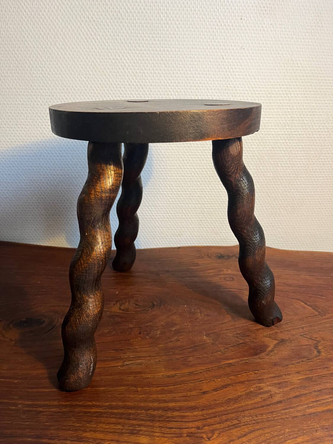 Round wooden tripod stool