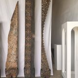 Indonesian construction element in carved wood with intertwined plant motifs mounted on a base (fri