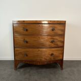 English commode from the George III Regency period, bombe shape in mahogany veneer.