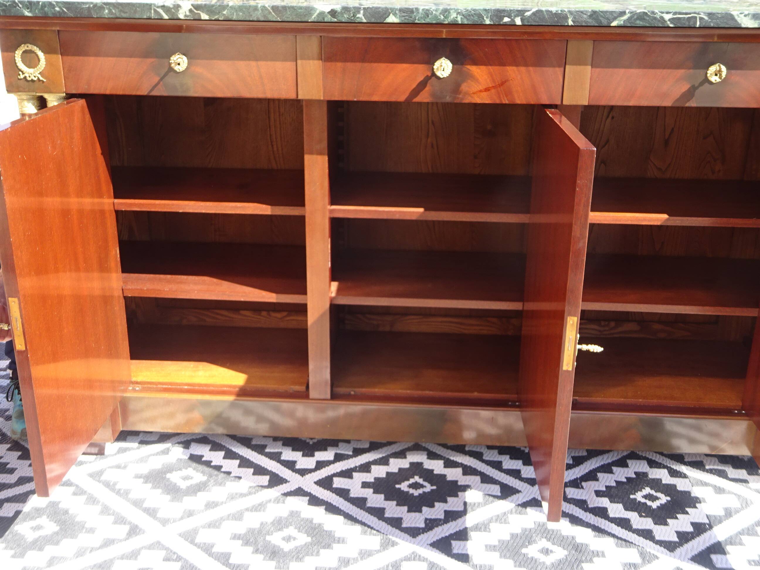 Flamed mahogany enfilade with sea green marble in Empire style.