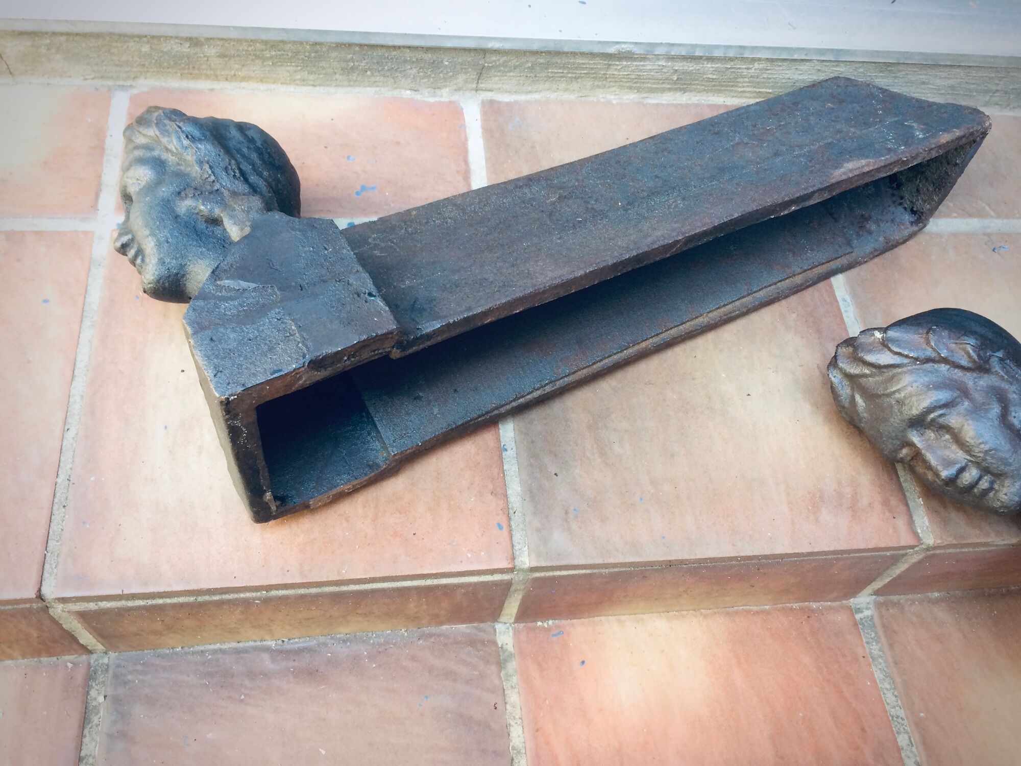 Pair of cast-iron chenet characters with laurels