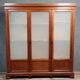 Large pine bookcase with three doors, fitted with frosted glass.