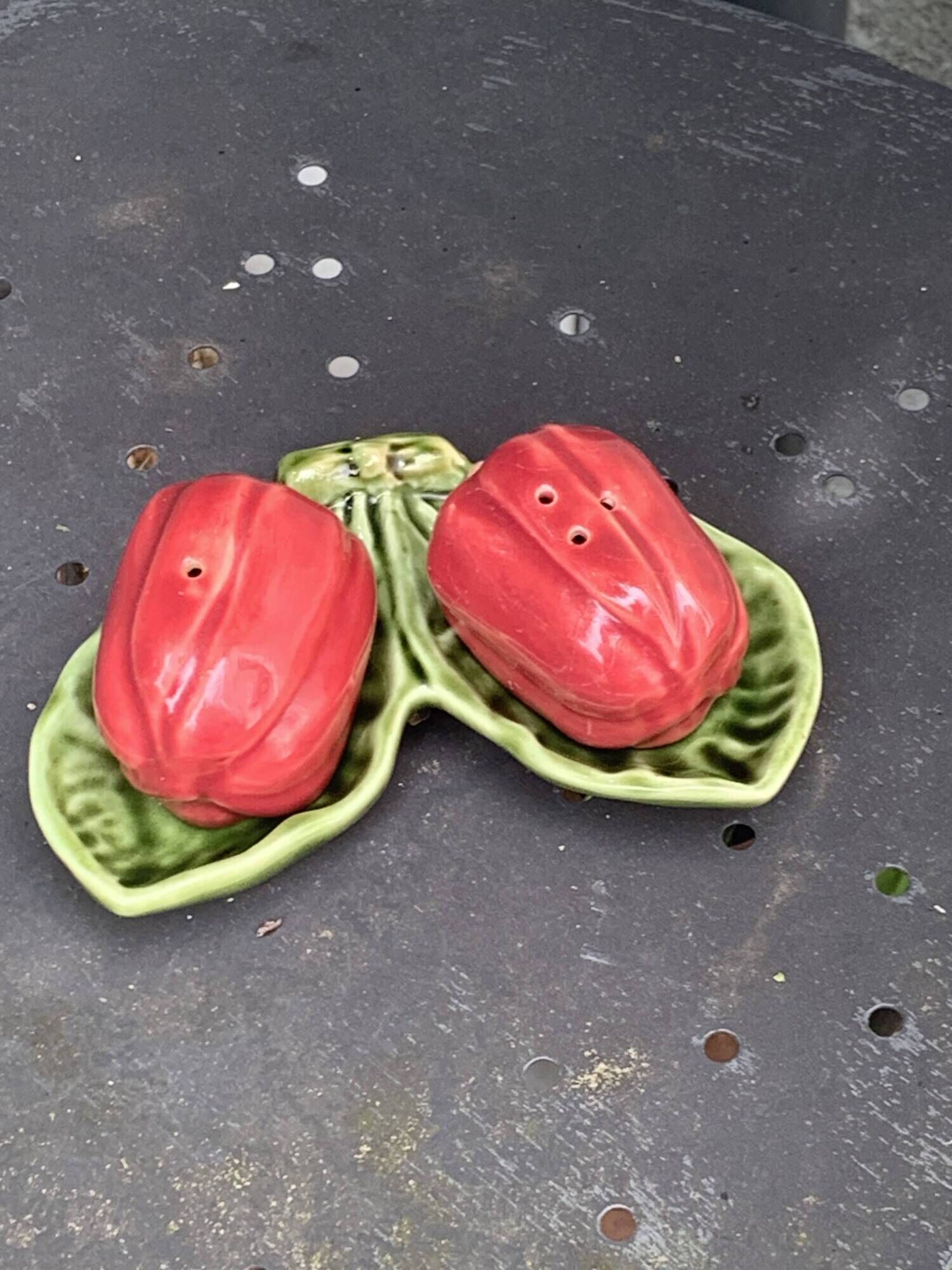 Ceramic salt shakers, slip in the shape of peppers.