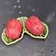 Ceramic salt shakers, slip in the shape of peppers.