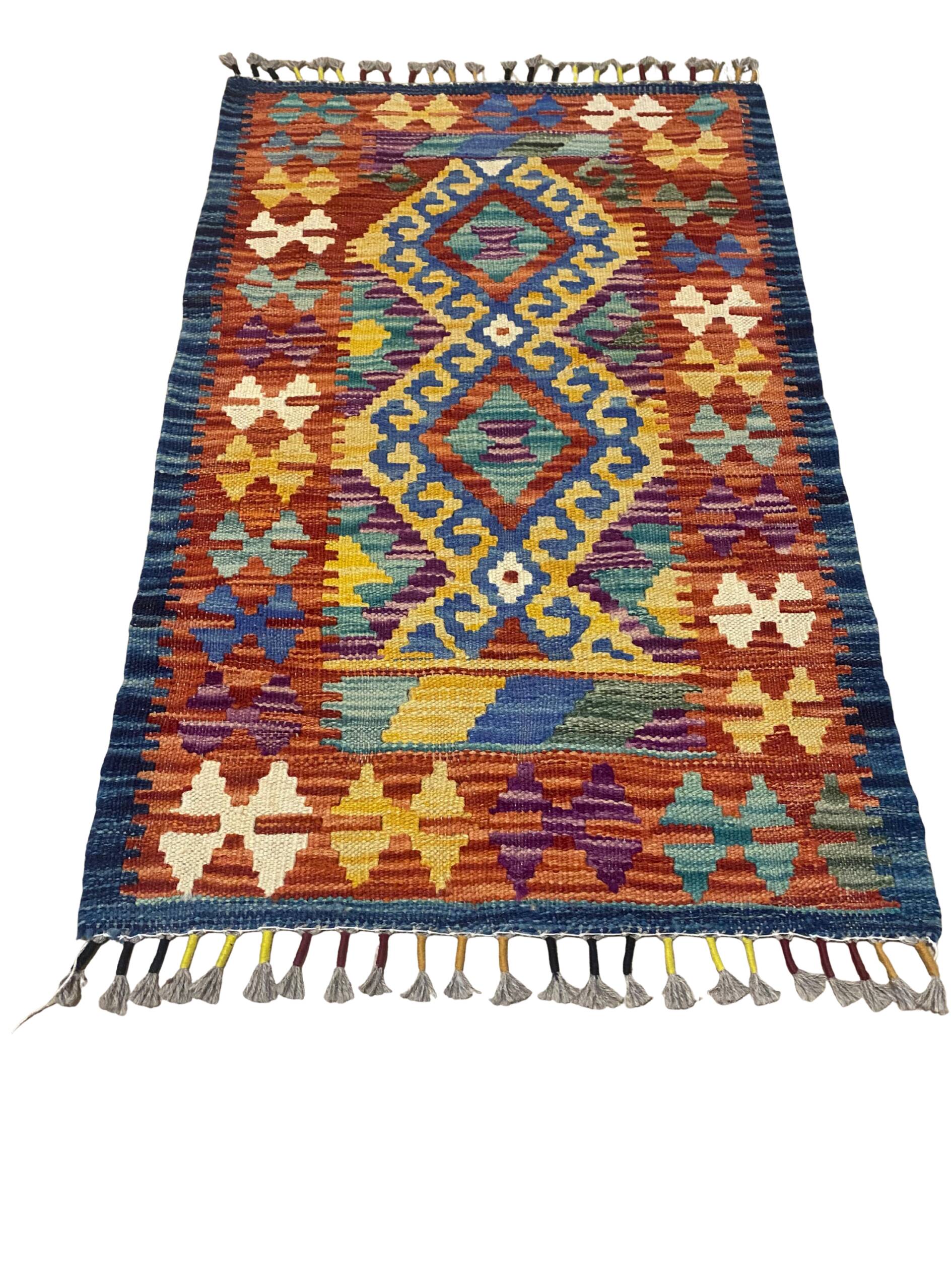Afghan kilim rug in multicolored wool, geometric patterns