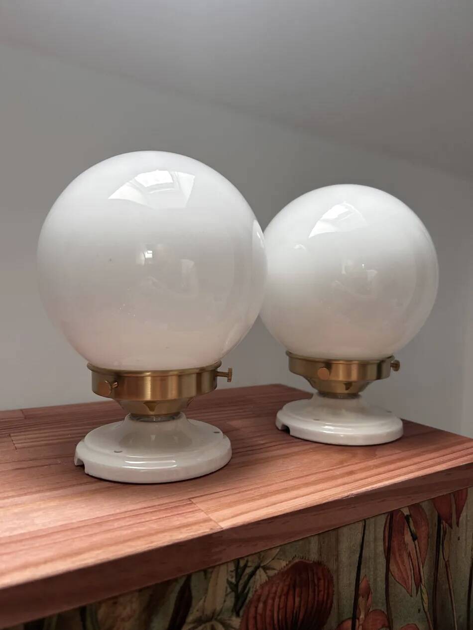 Pair of wall sconces with white opaline globes