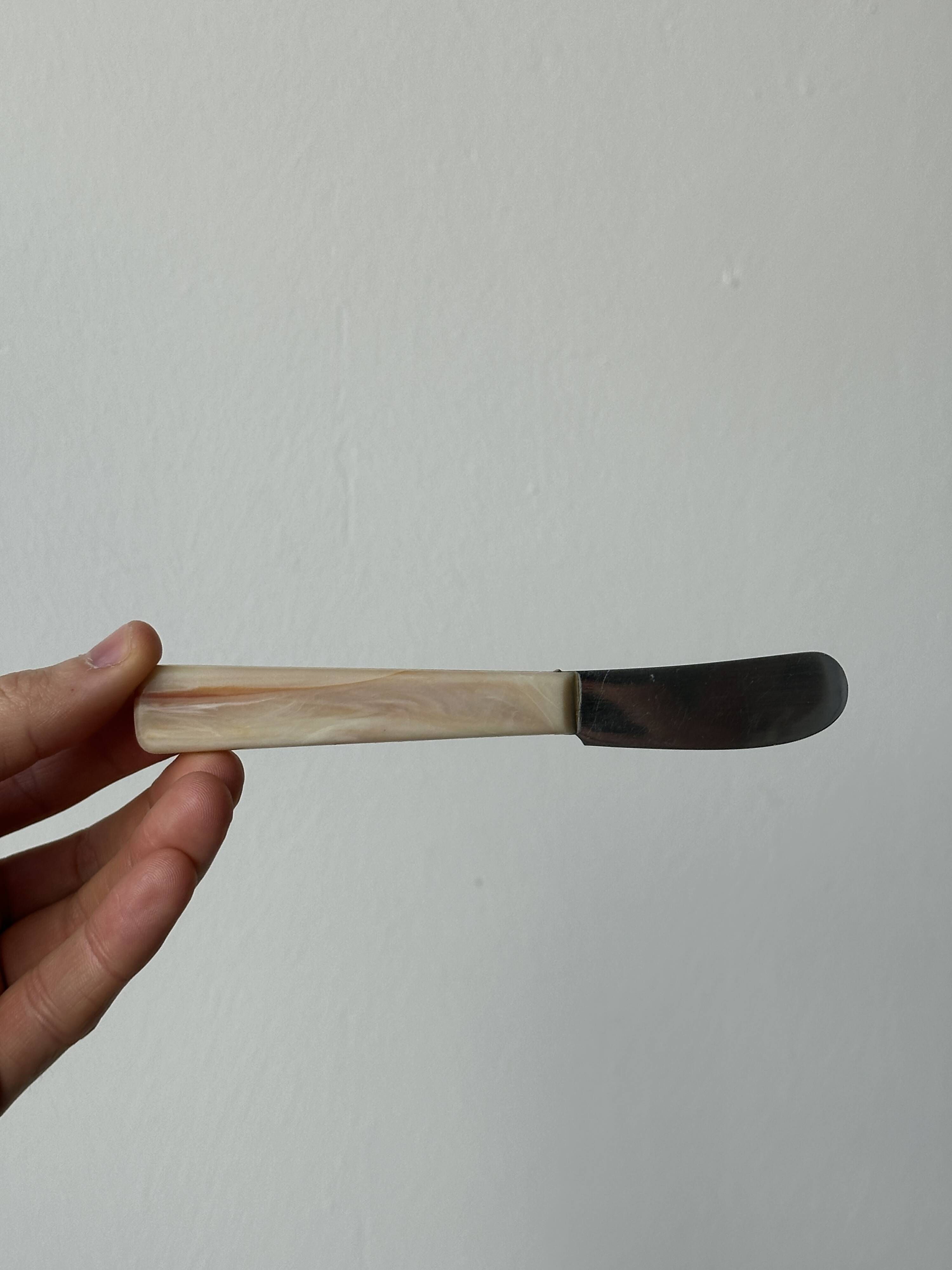 Pink bakelite butter knives.