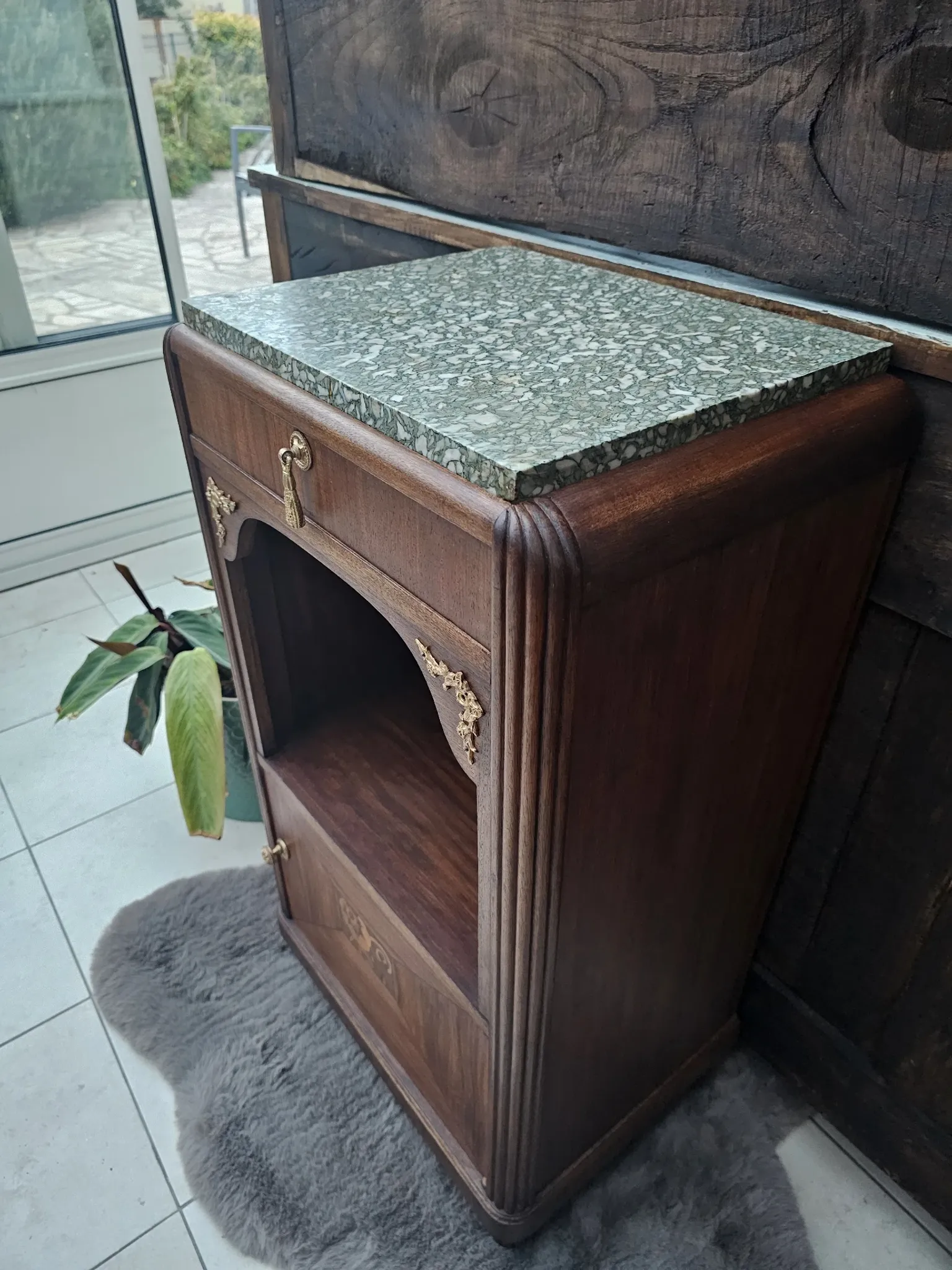 Art Deco bedside table with a green marble top.