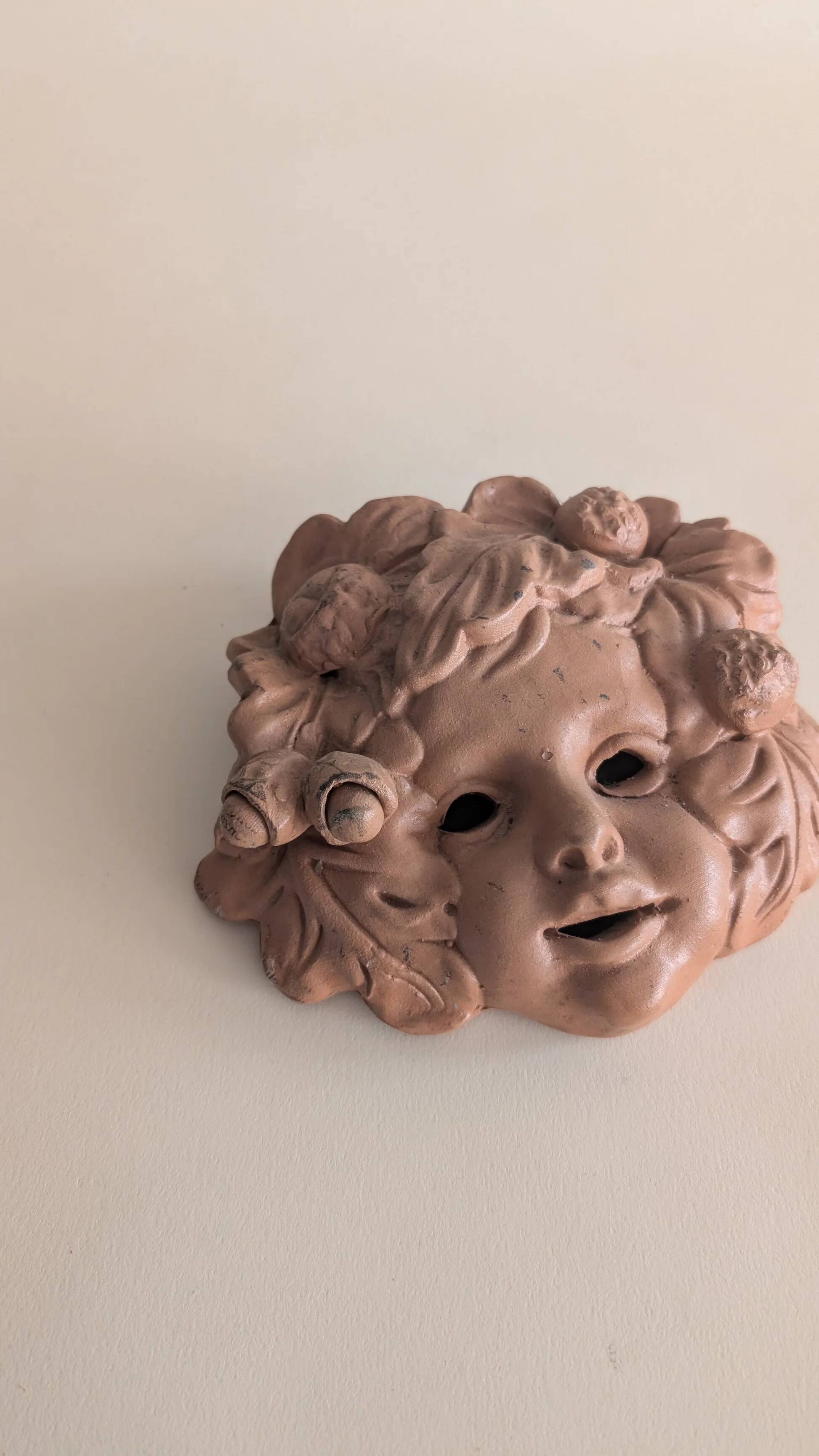 Vintage terracotta wall mask - flowery child's face