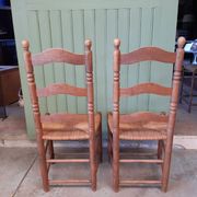 Pair of country-style straw chairs.
