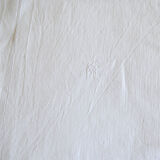 Old white tablecloth embroidered in linen