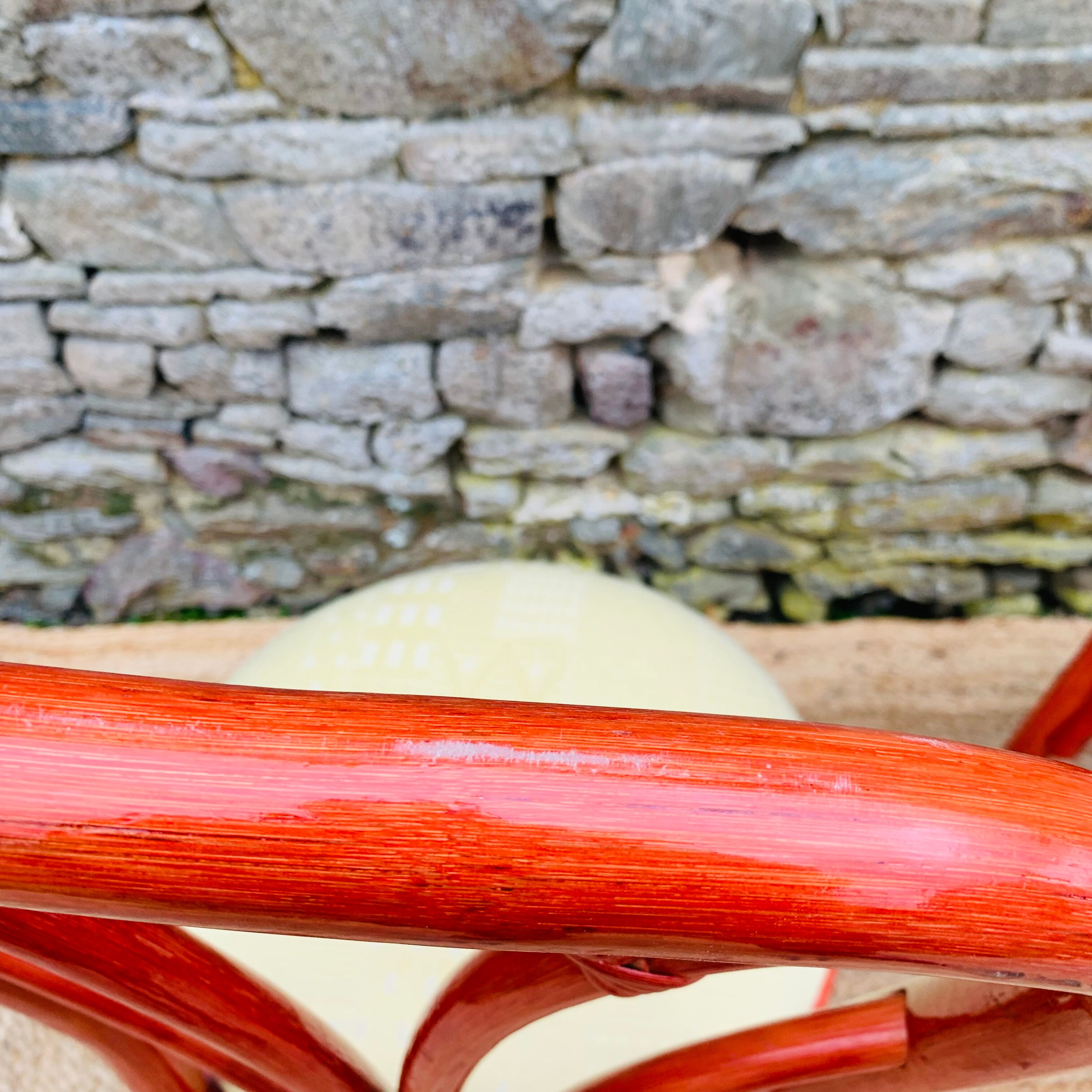 Pair of red rattan chairs and fabric