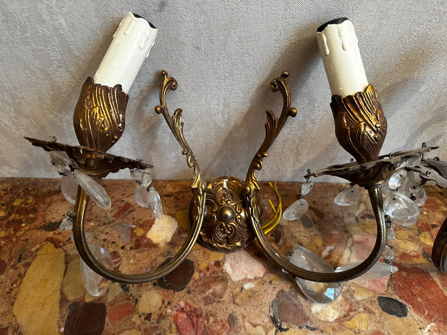 Pair of Louis XV style wall sconces in gilded bronze with glass pendants.