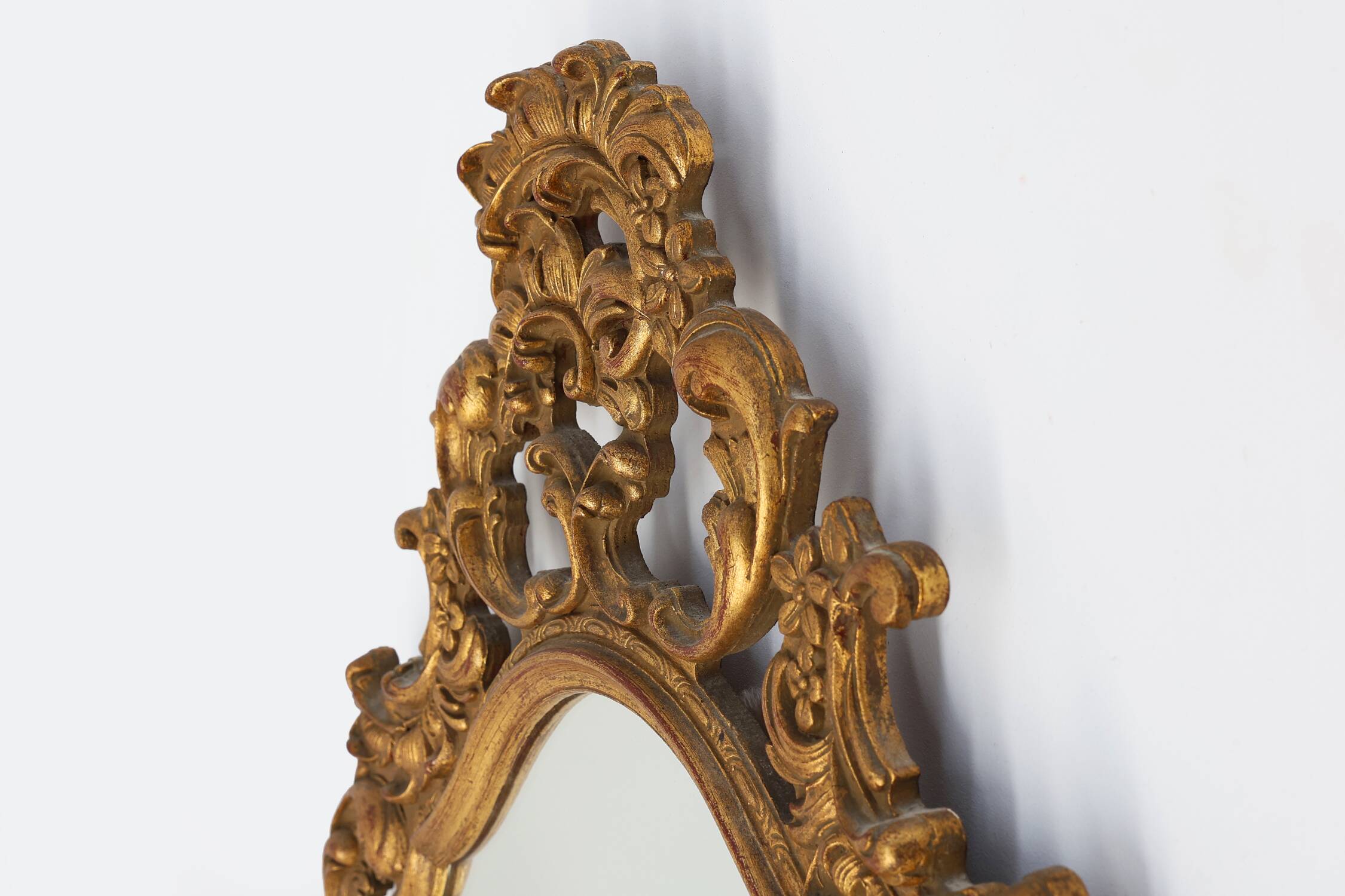 Baroque style oval wall mirror in gilded wood, France