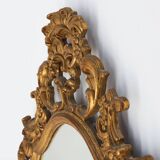 Baroque style oval wall mirror in gilded wood, France