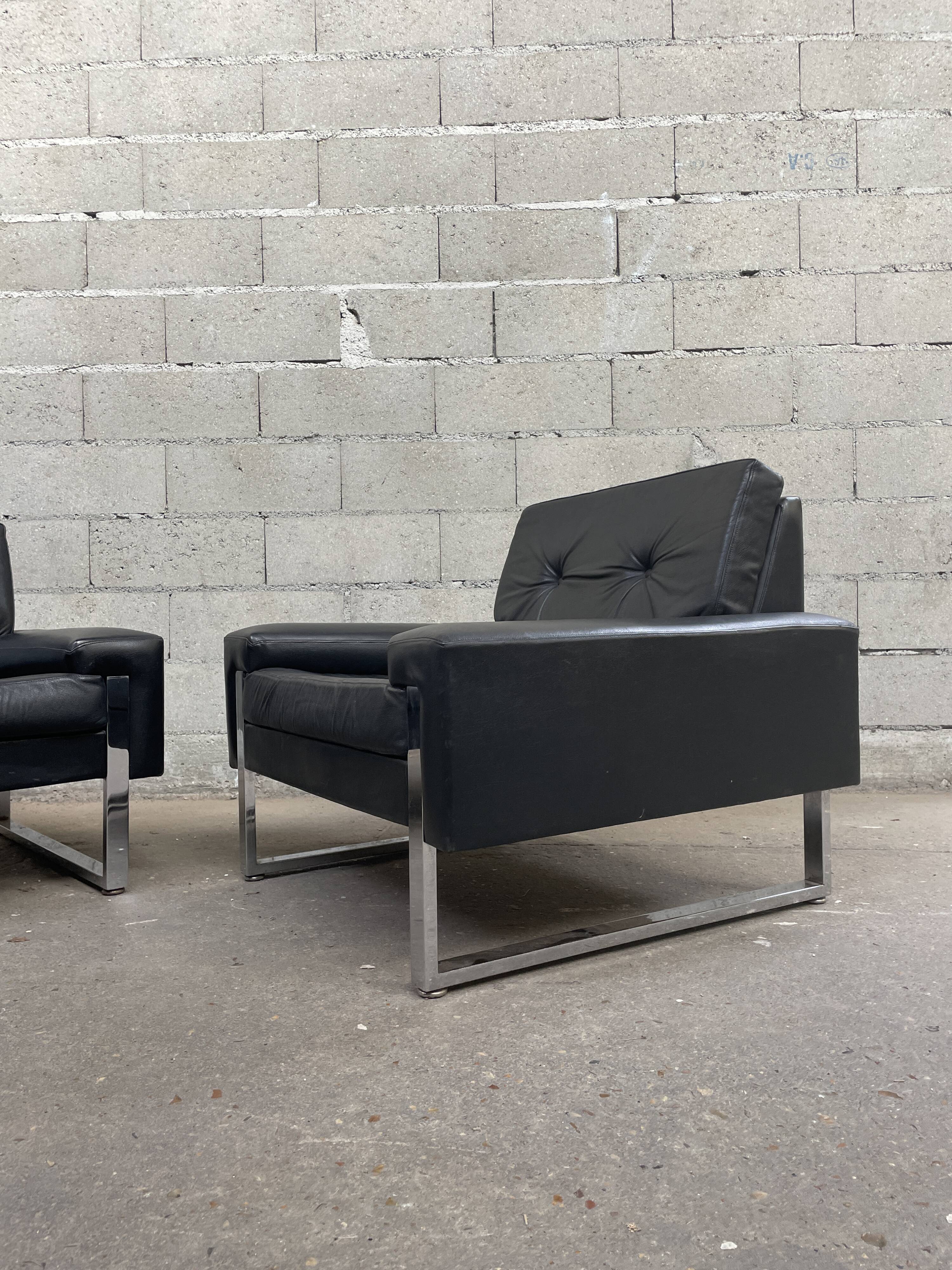 Pair of black leather armchairs