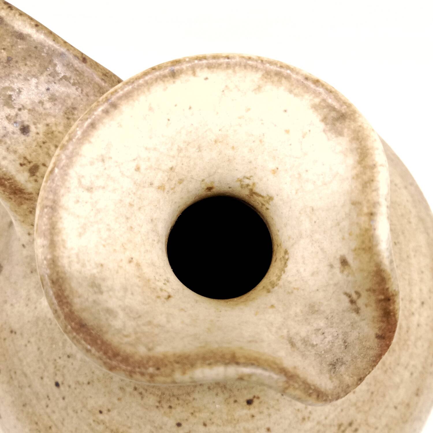 Vintage speckled brown stoneware jug in a round shape.