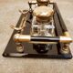 Hence the art deco inkwell on jet plate brass finishes