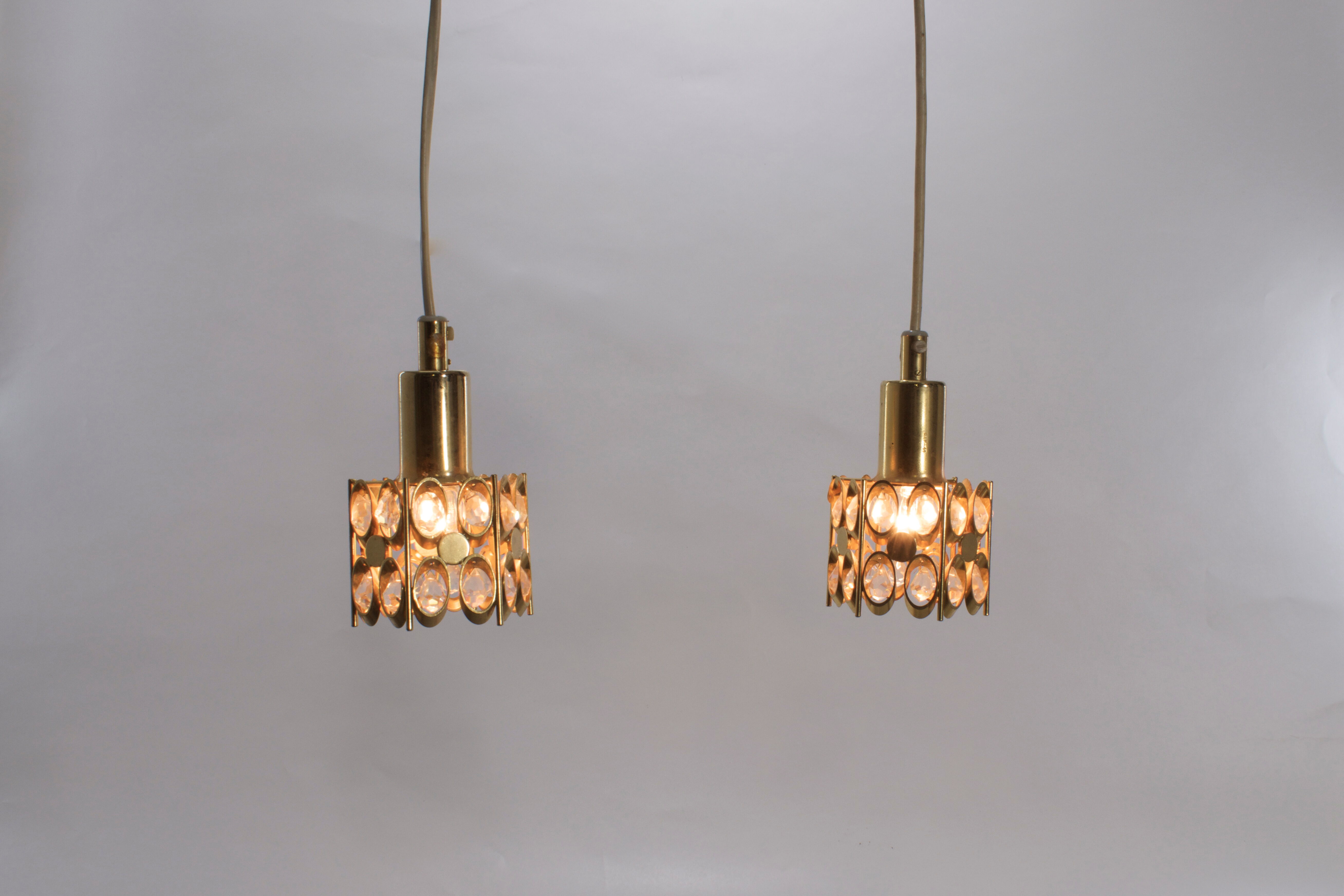 Two pendant lights in gilded brass and crystal, by Palwa, design 1960