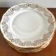 8 white and gold porcelain dessert plates